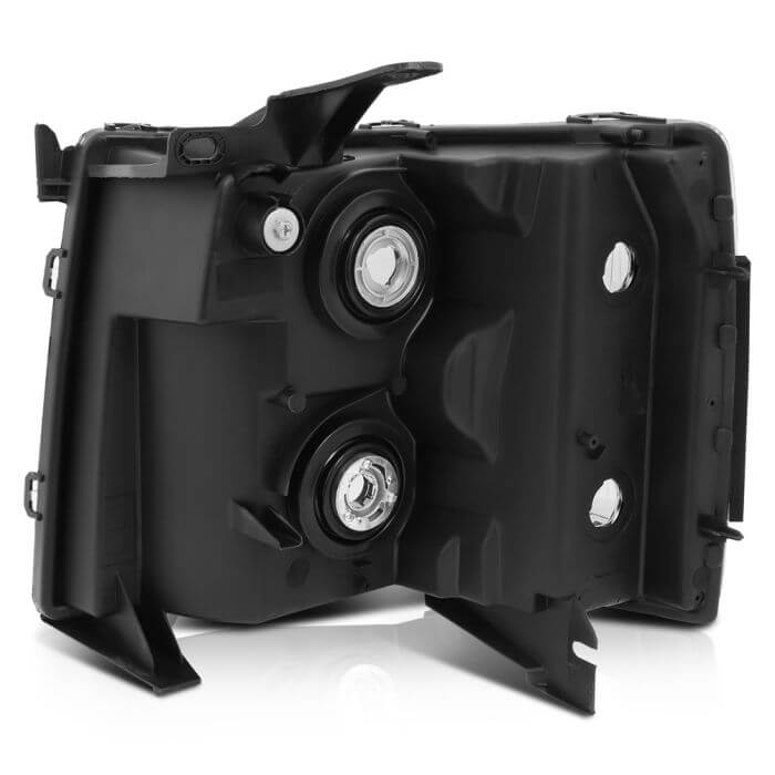 Back side of replacement black housing headlight assembly for 2007–2013 Chevy Silverado 3500 with halogen bulb openings